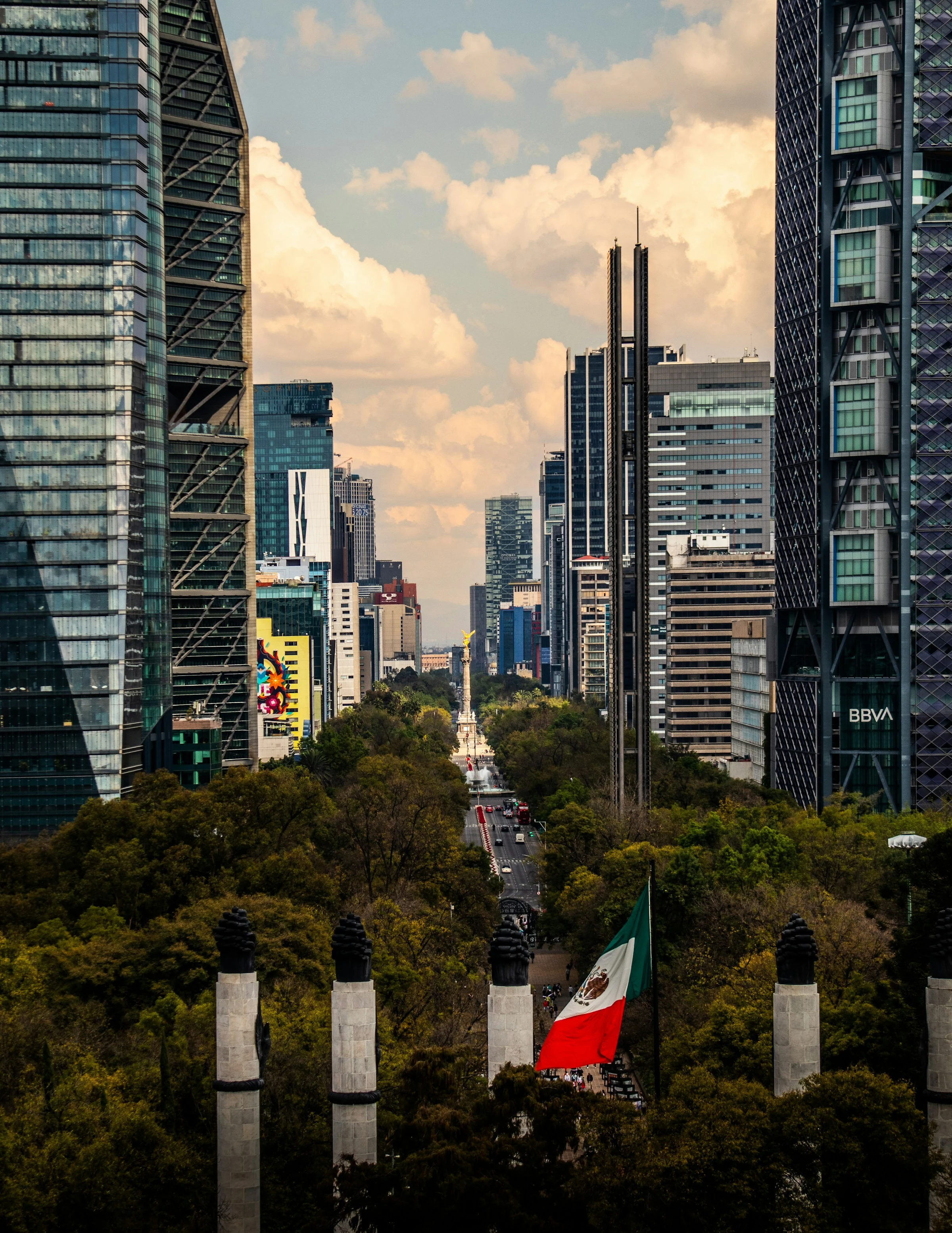 Contemporary towers frame the Angel of Independence and Paseo de la Reforma in Mexico City