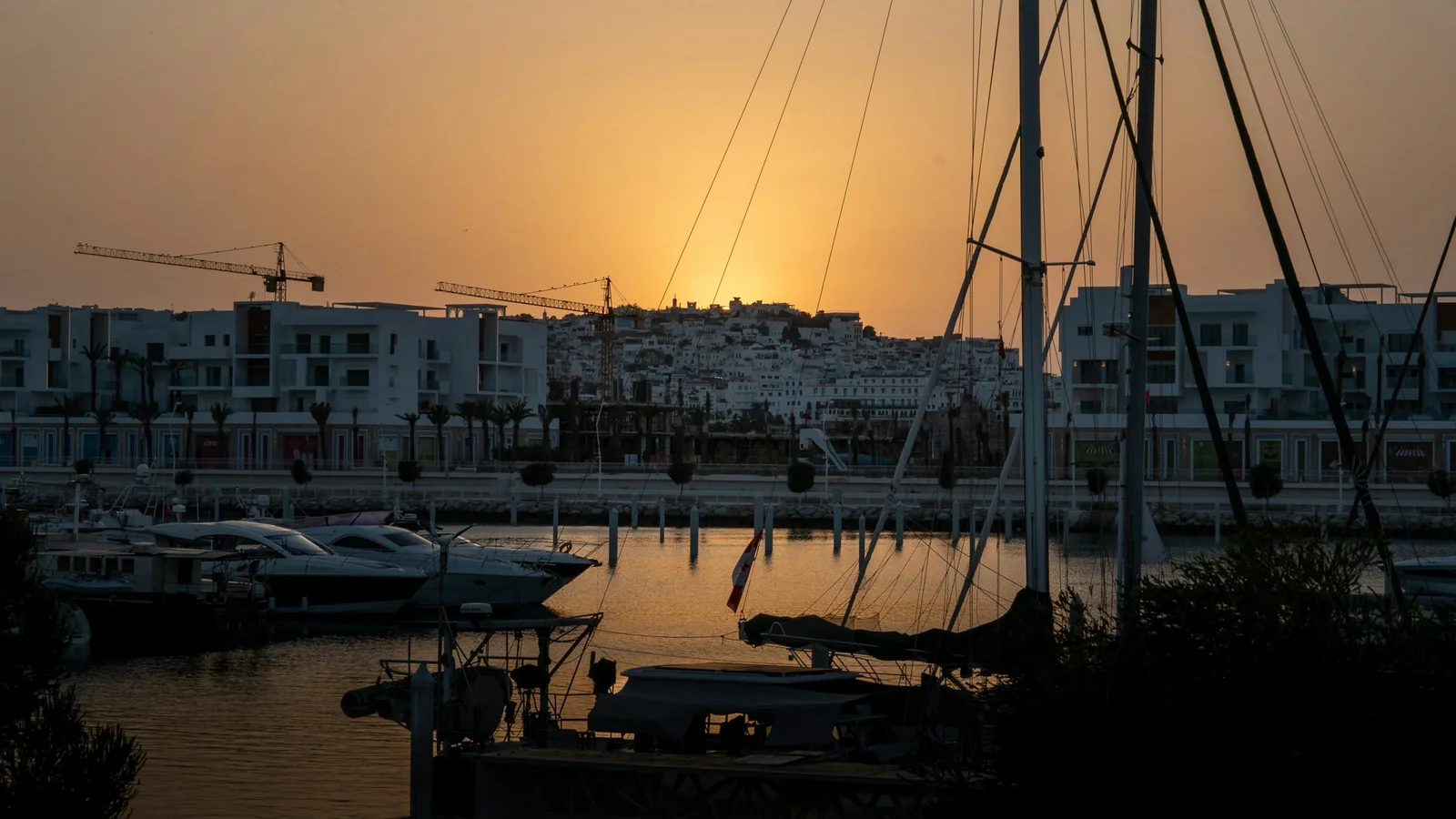 Yachts and contemporary waterfront buildings at Tangier’s marina at sunset