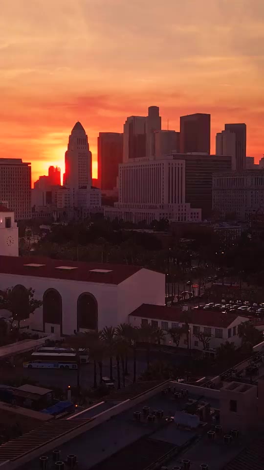 The Los Angeles skyline beneath an orange sunset